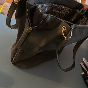 Great big grey bag with gold zippers down the side.